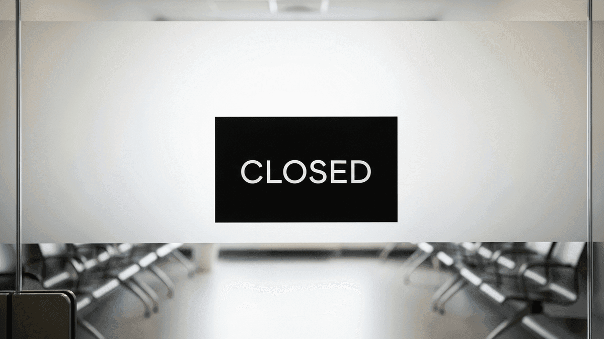 Closed panel sign visible through clinic waiting room glass doors